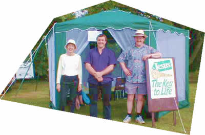 Three Ministers - Jenny Dann (St Michael's), Phil Snelson (Shefford Methodists) and Steve Summerfield.(Shefford Baptists) outside the 'Tent of Tranquility' at Shefford Gala, June 2003. From an original photograph, Copyright Shirley Course, Shefford Methodist Church, June 2003