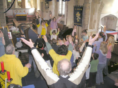 PHOTO: Sandra and the Benefice Choir lead the Sparks in an energetic rendition of the "Wa Wa" song