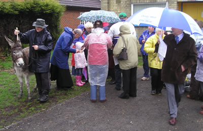 members of the congregation meeting at the Community hall before the procession