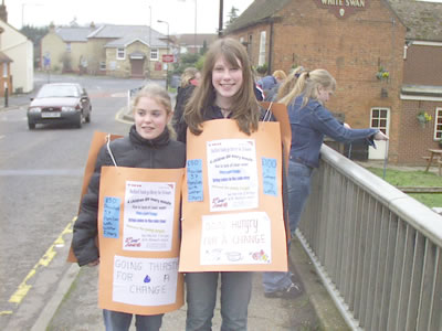 Photo: two of the YNU members wearing 'sandwich boards' to promote the event
